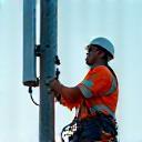 Technician overseeing 5G antenna installation